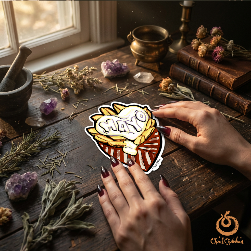 A mayo and fries illustrated graphic sticker on the table with hands of an edgy witchy woman in a bohemian witchy vibe room